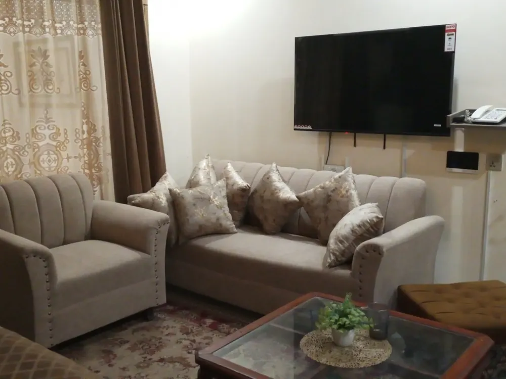 Beige sofa set with a channel-back chair in a living room